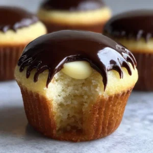 Delicious Boston Cream Pie Cupcakes topped with chocolate frosting