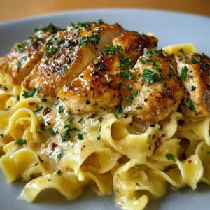 Delicious chicken served with creamy buttered noodles for a comforting meal.