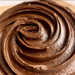 Delicious chocolate fudge frosting on a freshly baked cake