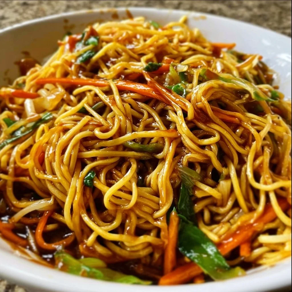 Delicious Chow Mein with authentic Chow Mein sauce garnished with fresh vegetables.