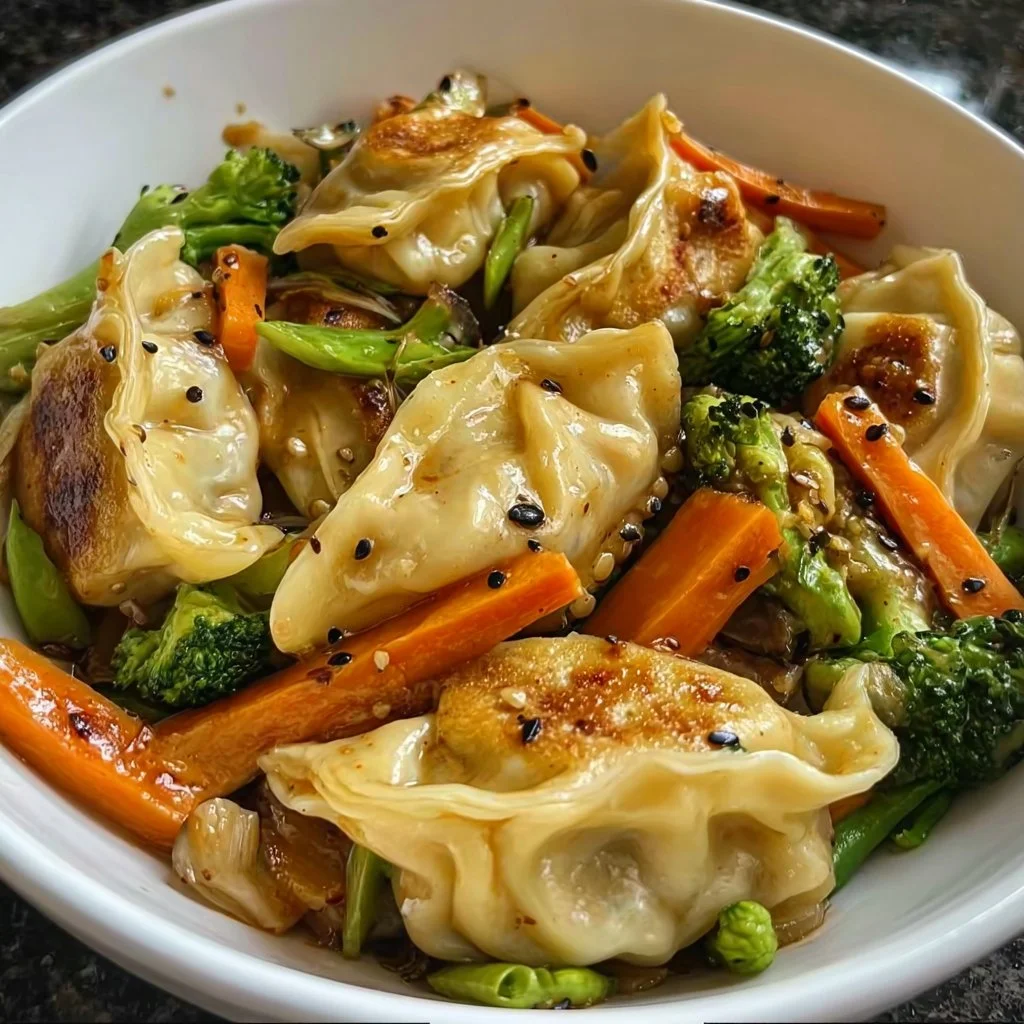 A vibrant bowl of potsticker stir fry with colorful vegetables and sauce