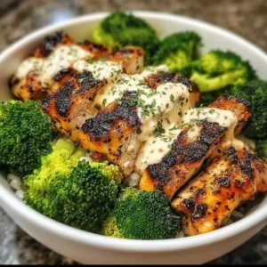Grilled chicken bowls with broccoli and creamy garlic sauce on a plate