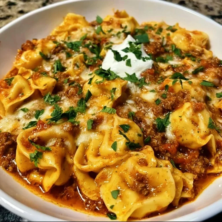 Cheesy beef enchilada tortellini served on a plate with toppings