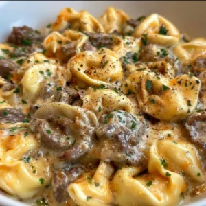 Philly Cheesesteak Tortellini Pasta dish with melted cheese and savory meat