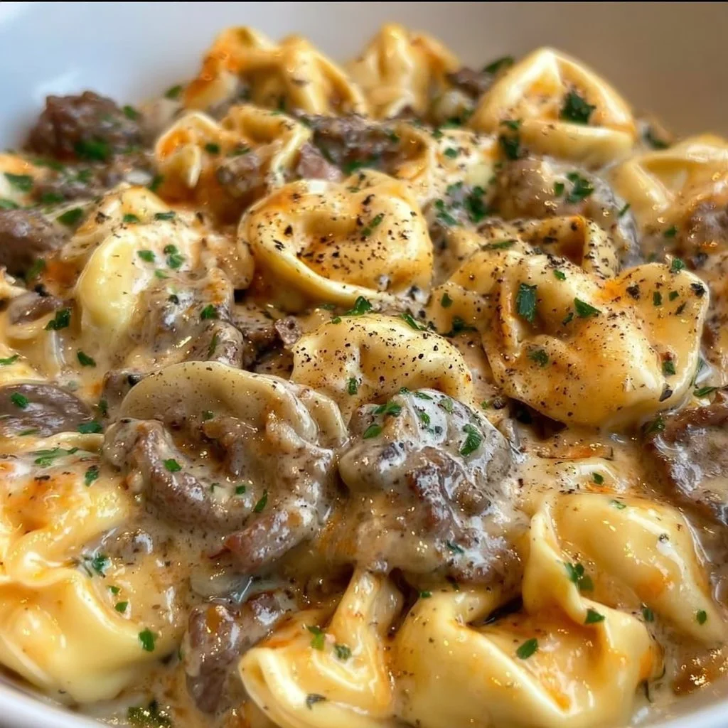 Philly Cheesesteak Tortellini Pasta dish with melted cheese and savory meat