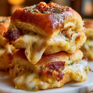 Baked Italian Grinder Sliders topped with melted cheese and fresh ingredients